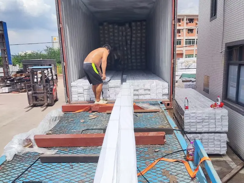 The workers are loading the truck onto the truck