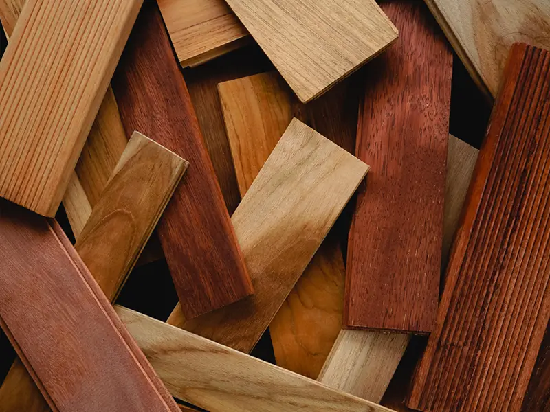 Picture of WPC boards and natural wooden boards stacked haphazardly together