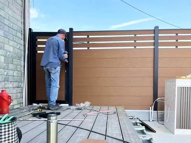 Photos of construction workers installing WPC fence panels