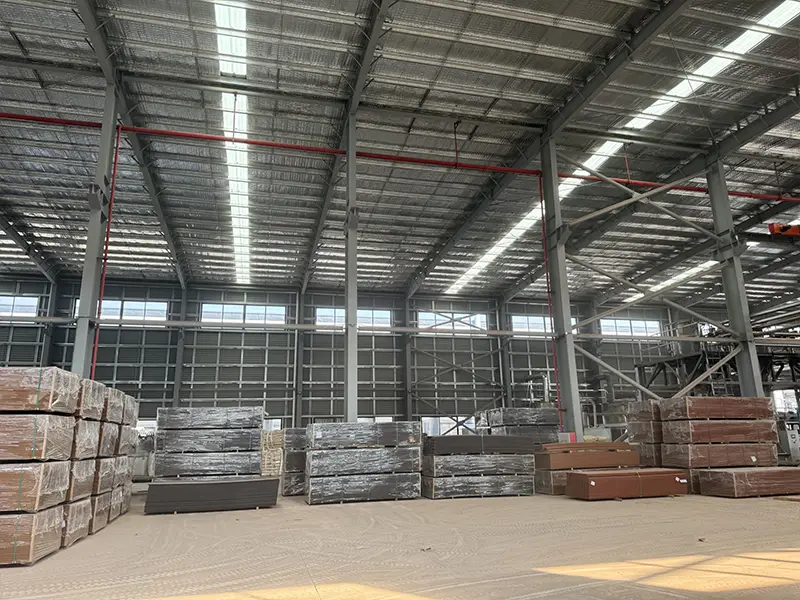 There are many pictures of plastic wood boards piled up in the LEBK factory warehouse
