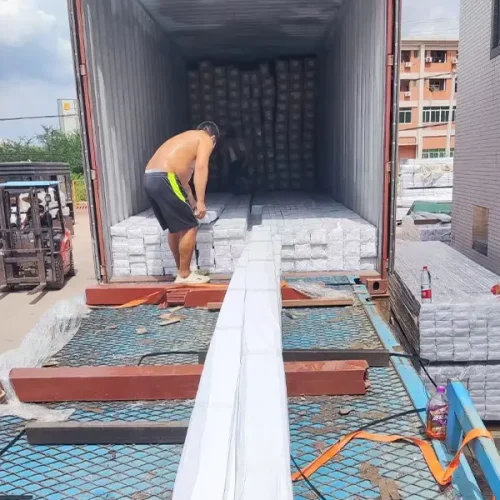 The workers are loading the truck onto the truck