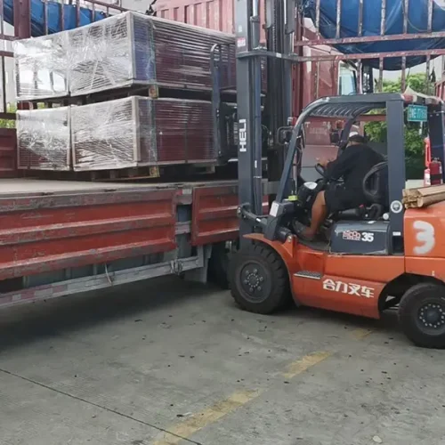 The picture of a forklift delivering plastic wood boards onto a truck